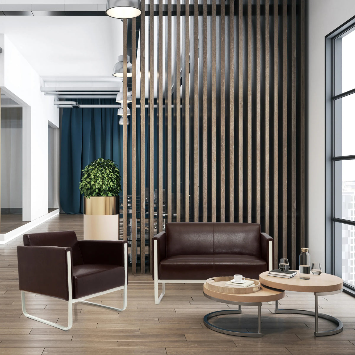 Poltrona imbottita marrone ARUBA con struttura in metallo bianco in un ambiente ufficio moderno di hjh OFFICE