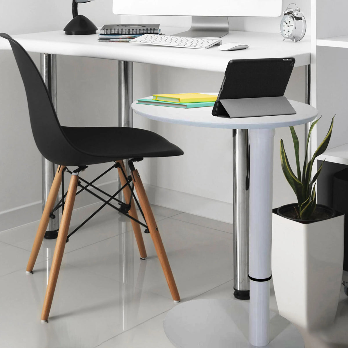 Scrivania in piedi bianca STAND III con superficie di appoggio rotonda, sedia nera e una pianta da appartamento di hjh OFFICE