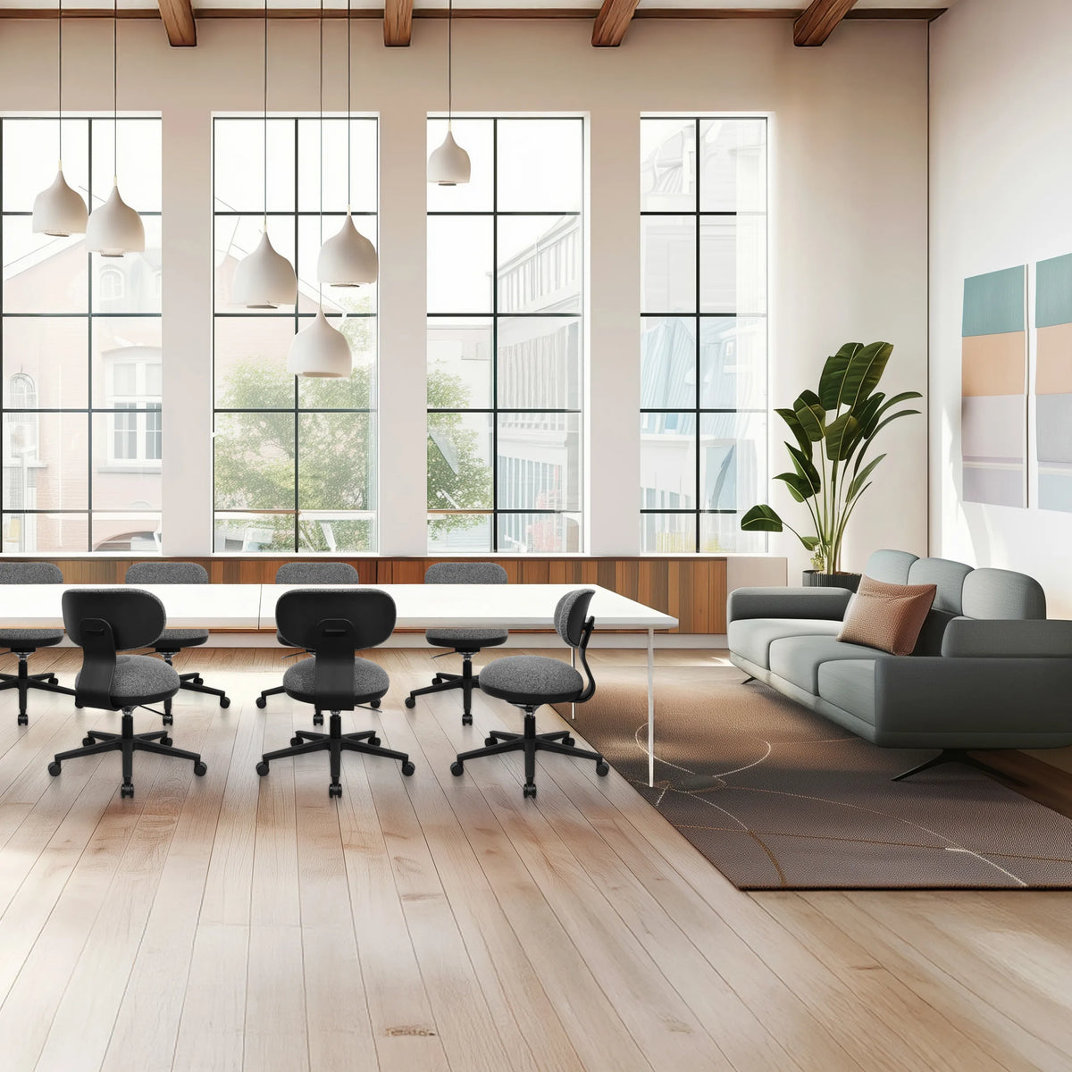 Sedia Home Office SITMOTION B grigia con ruote e braccioli in un ufficio luminoso di hjh OFFICE