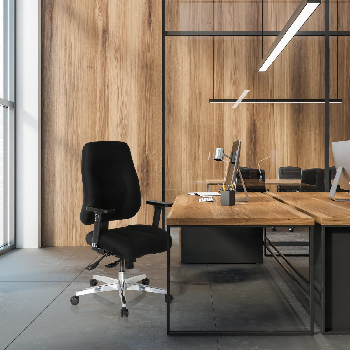 Sedia da ufficio professionale ZENIT COMFORT nera con braccioli e ruote a una scrivania di hjh OFFICE