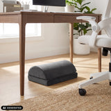 Poggiapiedi Podi Velvet 1 nero sotto una scrivania di hjh OFFICE (immagine generata dall’IA)