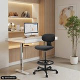 Sedia da lavoro WORK MF2 nera con poggiapiedi e rotelle davanti a una scrivania bianca di hjh OFFICE (immagine generata dall’IA)