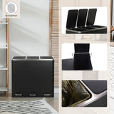 Cestino nero Clean 9 con coperchio argento accanto a una scrivania di hjh OFFICE