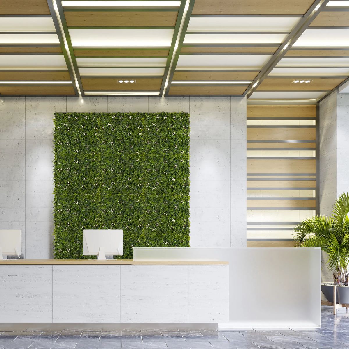 Pannello vegetale verde MORE GREEN I come verde verticale su una parete in cemento chiaro in un'area reception di hjh OFFICE