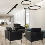 Tre Poltrone Lounge BAVERO nere in ecopelle in una lounge per ufficio moderna di hjh OFFICE